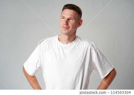 Portrait of a young handsome male in casual clothes on gray background Portrait of a young handsome male in casual clothes on gray background 114503304