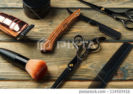 Hairdressing barber tools on wooden background close up Hairdressing barber tools on wooden background close up 114503416