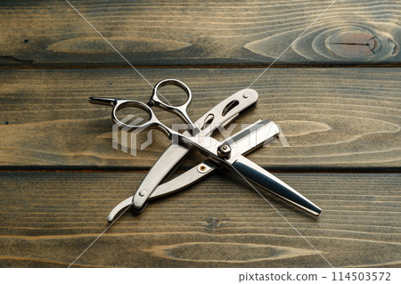 Hairdressing professional scissors on wooden background close up 114503572