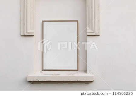 Blank vertical wooden picture frame, poster mockup. Elegant niche with classic pillars. Architectural stucco detail of old building. Chambranle, decorative ledge. Beautiful facade decor in beige Blank vertical wooden picture frame, poster mockup. Elegant niche with classic pillars. Architectural stucco detail of old building. Chambranle, decorative ledge. Beautiful facade decor in beige 114505220