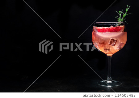 Fancy cocktail with fresh fruit. Gin and tonic drink with ice at a party 114505482