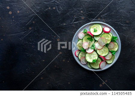 Fresh cucumber and radish salad with parsley, overhead flat lay shot 114505485