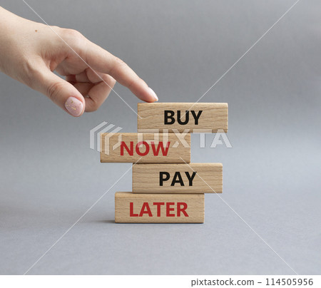 Buy now Pay later symbol. Concept word Buy now Pay later on wooden block. Businessman hand. Beautiful grey background. Business and Buy now Pay later concept. Copy space Buy now Pay later symbol. Concept word Buy now Pay later on wooden block. Businessman hand. Beautiful grey background. Business and Buy now Pay later concept. Copy space 114505956