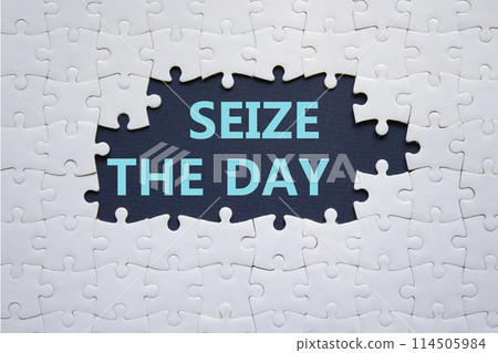 Seize the day symbol. White puzzle with words Seize the day. Beautiful deep blue background. Business and Seize the day concept. Copy space. Seize the day symbol. White puzzle with words Seize the day. Beautiful deep blue background. Business and Seize the day concept. Copy space. 114505984