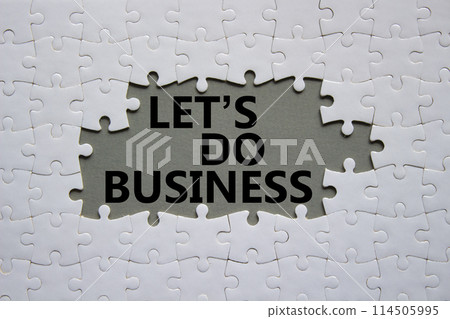 Lets do business symbol. Concept words Lets do business on white puzzle. Beautiful grey green background. Business and Lets do business concept. Copy space. 114505995