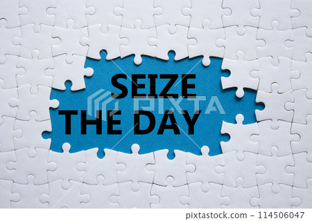 Seize the day symbol. White puzzle with words Seize the day. Beautiful blue background. Business and Seize the day concept. Copy space. Seize the day symbol. White puzzle with words Seize the day. Beautiful blue background. Business and Seize the day concept. Copy space. 114506047