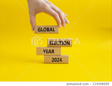Global Election year 2024 symbol. Concept words Global Election year 2024 on wooden blocks. Beautiful yellow background. Businessman hand. Business and Global Election year 2024 concept. Copy space Global Election year 2024 symbol. Concept words Global Election year 2024 on wooden blocks. Beautiful yellow background. Businessman hand. Business and Global Election year 2024 concept. Copy space 114506095