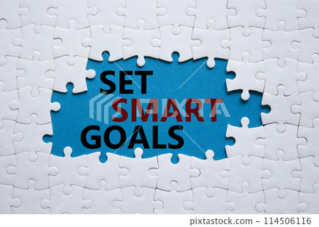 Set smart goals symbol. Concept words Set smart goals on white puzzle. Beautiful blue background. Business and Set smart goals concept. Copy space. Set smart goals symbol. Concept words Set smart goals on white puzzle. Beautiful blue background. Business and Set smart goals concept. Copy space. 114506116