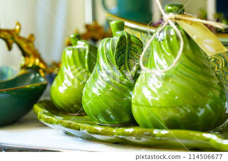 Green Ceramic Pear-Shaped Containers on a Plate With Rustic Kitchen Decor Green Ceramic Pear-Shaped Containers on a Plate With Rustic Kitchen Decor 114506677