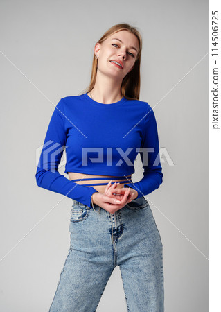 Smiling Woman in Black Top against gray background 114506725