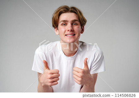 Young Man Giving Thumbs Up Sign 114506826