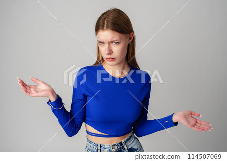 Young Woman in Blue Top Holding Out Hands Young Woman in Blue Top Holding Out Hands 114507069