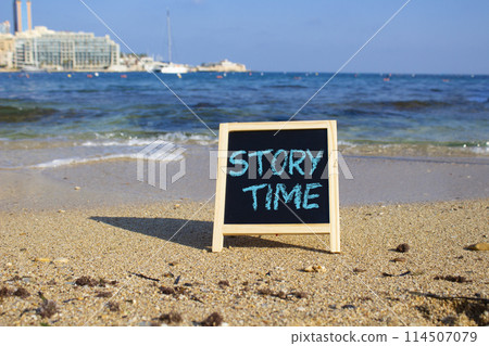 Story Time symbol. Concept word Story Time on black chalk background. Beautiful sea background. Business and Story Time concept. Copy space 114507079