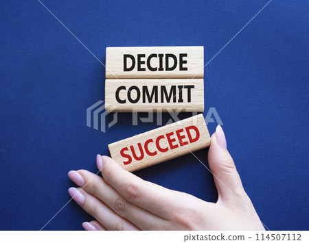 Decide Commit Succeed symbol. Concept words Decide Commit Succeed on wooden blocks. Businessman hand. Beautiful deep blue background. Business concept. Copy space. Decide Commit Succeed symbol. Concept words Decide Commit Succeed on wooden blocks. Businessman hand. Beautiful deep blue background. Business concept. Copy space. 114507112
