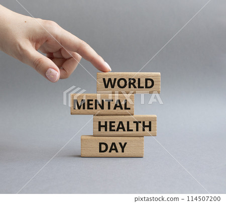 World Mental Health Day symbol. Wooden blocks with words World Mental Health Day. Businessman hand. Beautiful grey background. Health concept. Copy space. 114507200