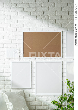 Varied Sized Photo Frames Displayed on a White Brick Wall Varied Sized Photo Frames Displayed on a White Brick Wall 114507223