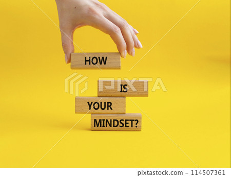 Mindset symbol. Wooden blocks with words How is your Mindset. Beautiful yellow background. Businessman hand. Business and How is your Mindset concept. Copy space. Mindset symbol. Wooden blocks with words How is your Mindset. Beautiful yellow background. Businessman hand. Business and How is your Mindset concept. Copy space. 114507361