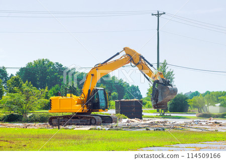 On construction site, an excavator loads construction concrete waste into dump container On construction site, an excavator loads construction concrete waste into dump container 114509166