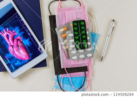 Cardiology doctor examines 3D radiology scan of rendering for patient heart during an examination in hospital on digital tablet Cardiology doctor examines 3D radiology scan of rendering for patient heart during an examination in hospital on digital tablet 114509284