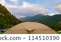 camping and tent with drops of night rain at dawn against the backdrop of the Austrian mountains 114510390