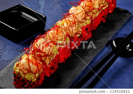 Red sushi rolls with avocado spread and shrimp tempura 114510931
