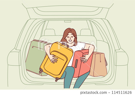 Woman tourist with travel suitcases sits in trunk of car, getting ready for trip to another city 114511626