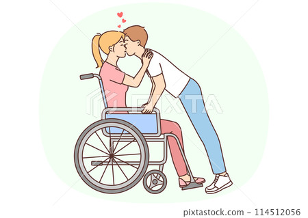 Man kissing disabled woman in wheelchair 114512056