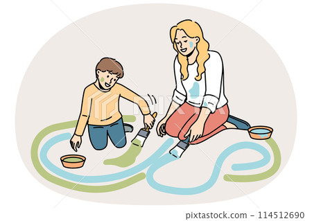 Smiling mother and son painting on ground 114512690
