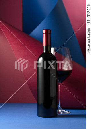 Bottle and glass of red wine. 114512936