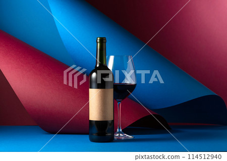 Bottle and glass of red wine. 114512940