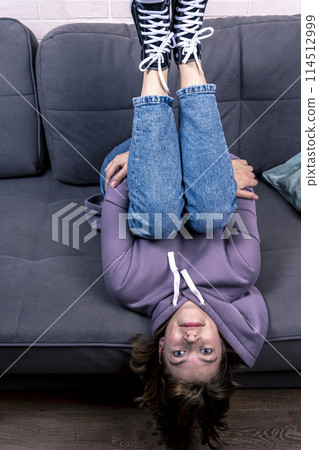 teenage girl, lying on the couch upside down teenage girl, lying on the couch upside down 114512999
