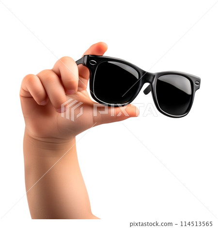 Child's hand holding sunglasses isolated on a white or transparent background. Close-up of black glasses in hand. Rest, holidays, sun protection. Vacation and travel concept. 114513565
