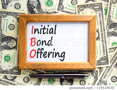 IBO initial bond offering symbol. Concept words IBO initial bond offering on beautiful wooden frame. Beautiful dollar bills background. Business IBO initial bond offering concept. Copy space. 114514630