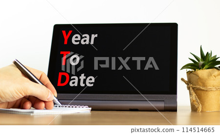 YTD year to date symbol. Concept words YTD year to date on beautiful black tablet. Beautiful white background. Businessman hand. Business YTD year to date concept. Copy space. YTD year to date symbol. Concept words YTD year to date on beautiful black tablet. Beautiful white background. Businessman hand. Business YTD year to date concept. Copy space. 114514665
