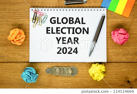 Global election year 2024 symbol. Concept words Global election year 2024 on beautiful white note. Beautiful wooden table background. Paper. Business Global election year 2024 concept. Copy space 114514669
