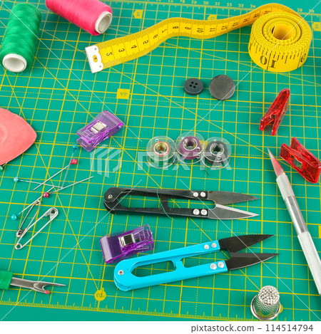 sewing accessories on a patchwork mat. sewing accessories on a patchwork mat. 114514794