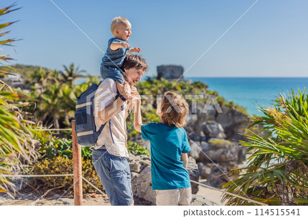 Father and two sons tourists enjoying the view Pre-Columbian Mayan walled city of Tulum, Quintana Roo, Mexico, North America, Tulum, Mexico. El Castillo - castle the Mayan city of Tulum main temple Father and two sons tourists enjoying the view Pre-Columbian Mayan walled city of Tulum, Quintana Roo, Mexico, North America, Tulum, Mexico. El Castillo - castle the Mayan city of Tulum main temple 114515541