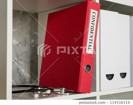 A folder labeled confidential and a medical stethoscope nearby. 114516319