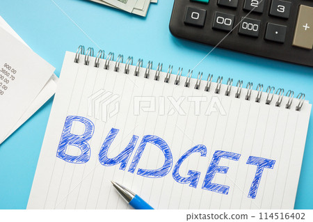 Handwritten inscription budget in a notepad next to the calculator. Handwritten inscription budget in a notepad next to the calculator. 114516402