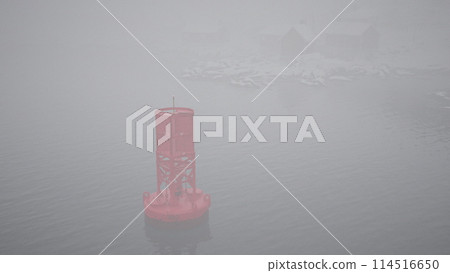 Red Metal Buoy Floating on Norwegian Sea 114516650