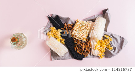 Funchoza, udon, black noodles, buckwheat and wheat pasta on a napkin top view web banner 114516787
