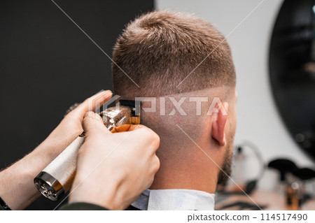 Shaving of male occiput by a hairdresser in the barbershop 114517490