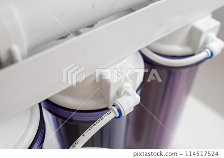 Close up tubes in a reverse osmosis system for water purification at home. Close up tubes in a reverse osmosis system for water purification at home. 114517524