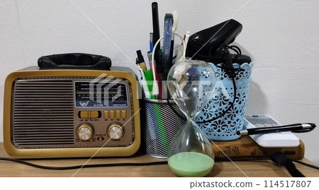 work table with pen, radio and hourglass 114517807