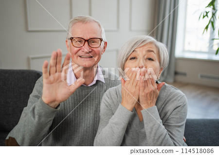 Happy senior woman man talk on video call with friends family. Mature old grandmother grandfather talking speaking with grown up children online. Older generation modern tech usage. Webcamera view Happy senior woman man talk on video call with friends family. Mature old grandmother grandfather talking speaking with grown up children online. Older generation modern tech usage. Webcamera view 114518086
