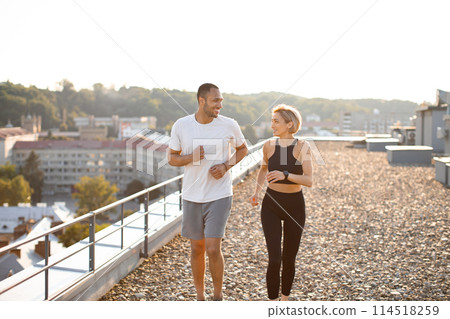 Young strong female and male athletes engaged in sports running. 114518259