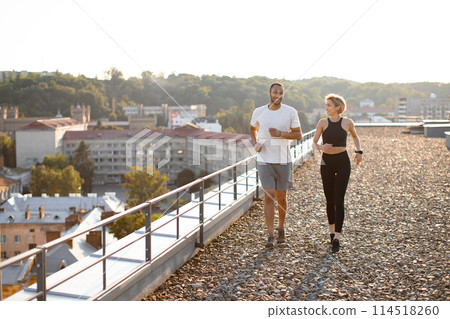 Young strong female and male athletes engaged in sports running. 114518260