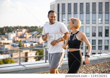 Happy man and woman jogging outdoors to maintain healthy body and mind. Happy man and woman jogging outdoors to maintain healthy body and mind. 114518261
