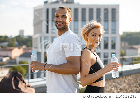 Young couple on terrace of high-rise building with urban city background. Young couple on terrace of high-rise building with urban city background. 114518283