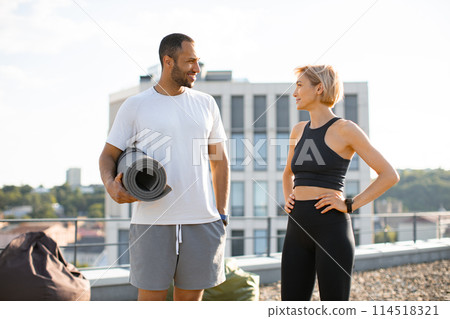 Young sporty man and woman resting after active sports warm-up. Young sporty man and woman resting after active sports warm-up. 114518321